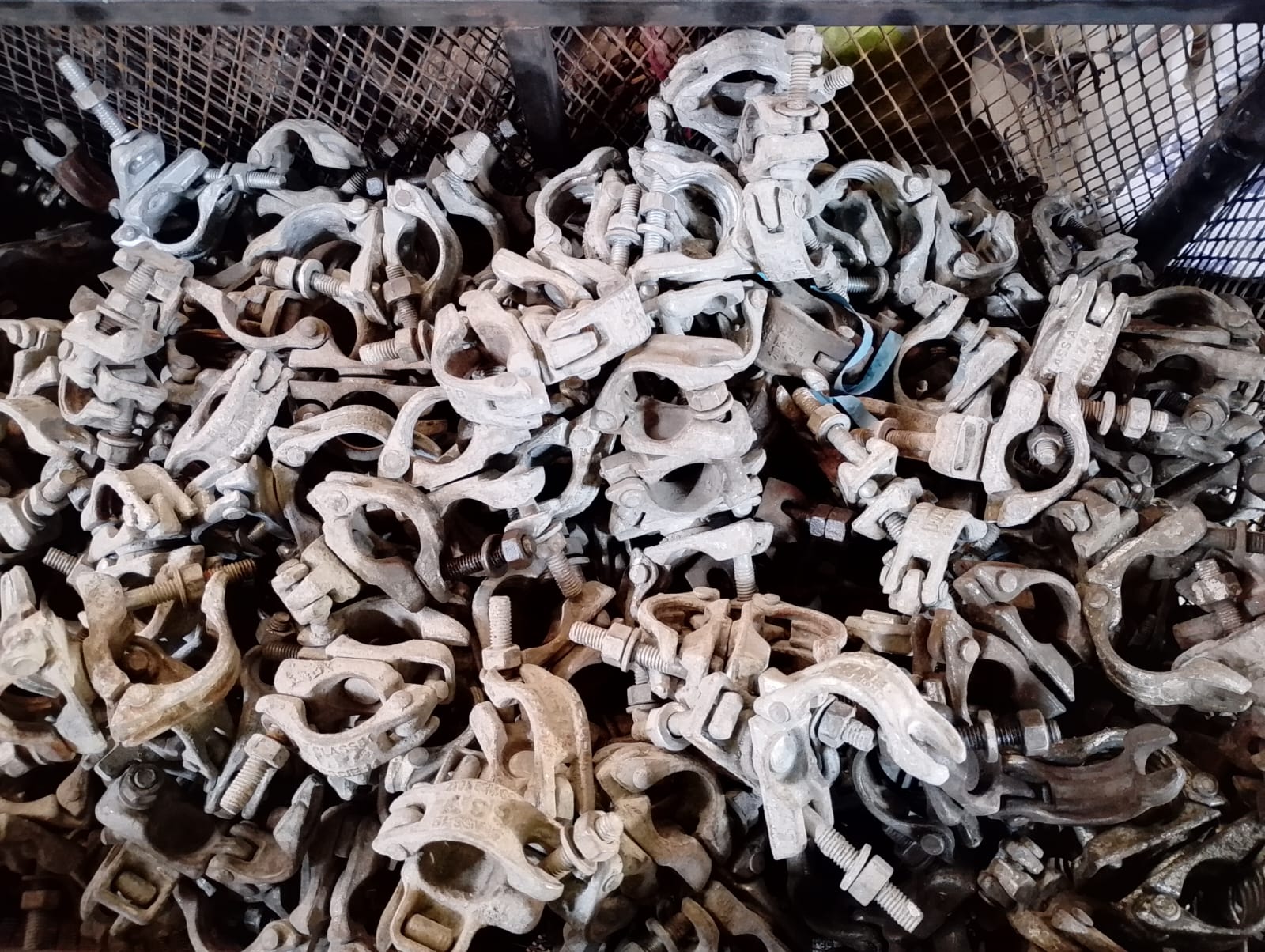 Swivel scaffolding clamps in a mesh bin