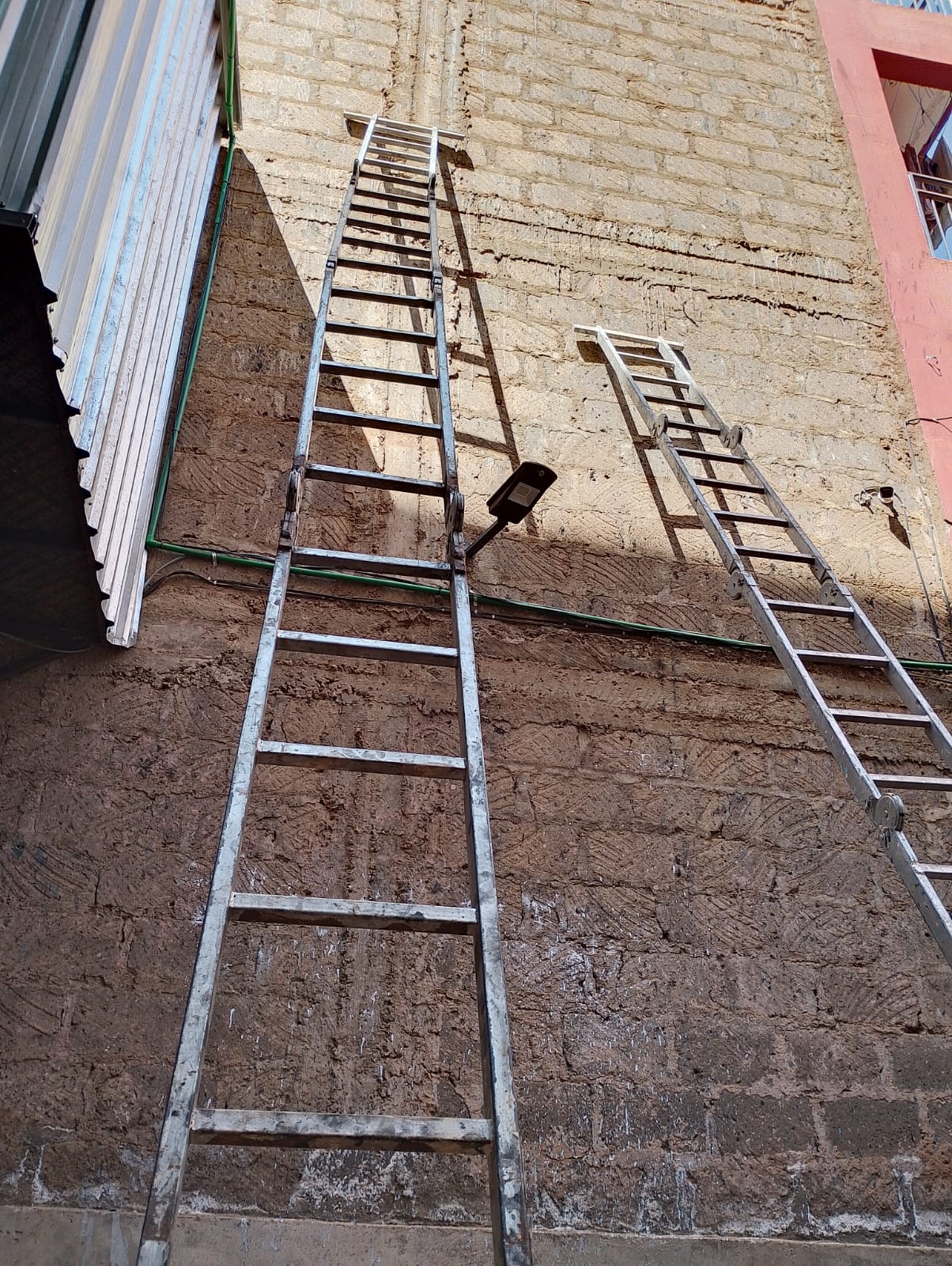 Aluminium extension ladders against a wall