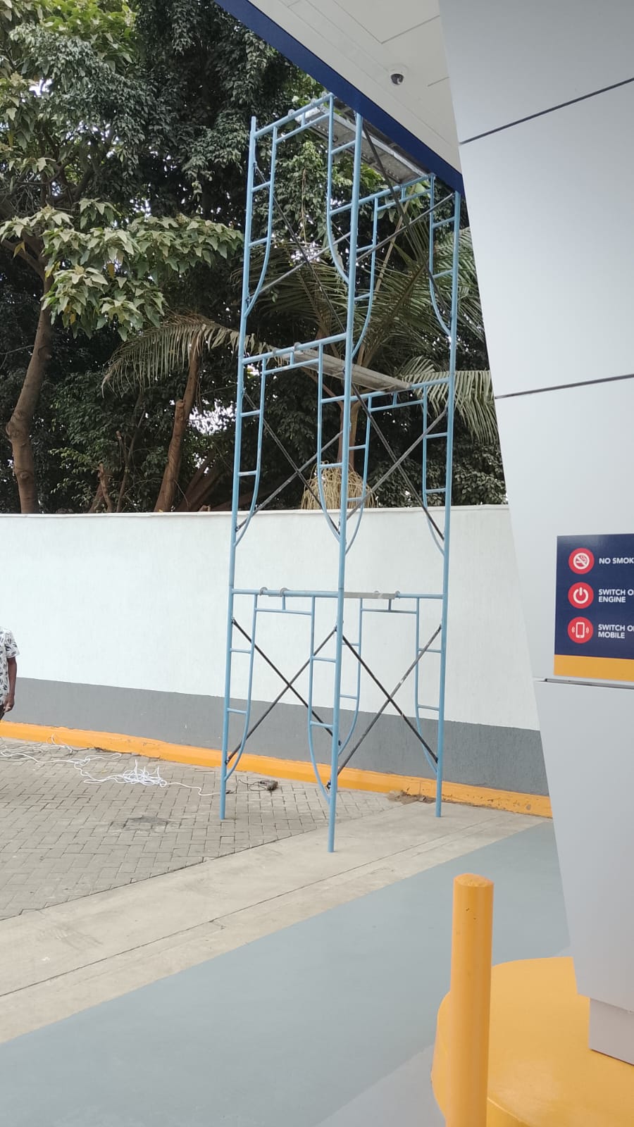 Tall mobile scaffold tower assembled on a commercial site