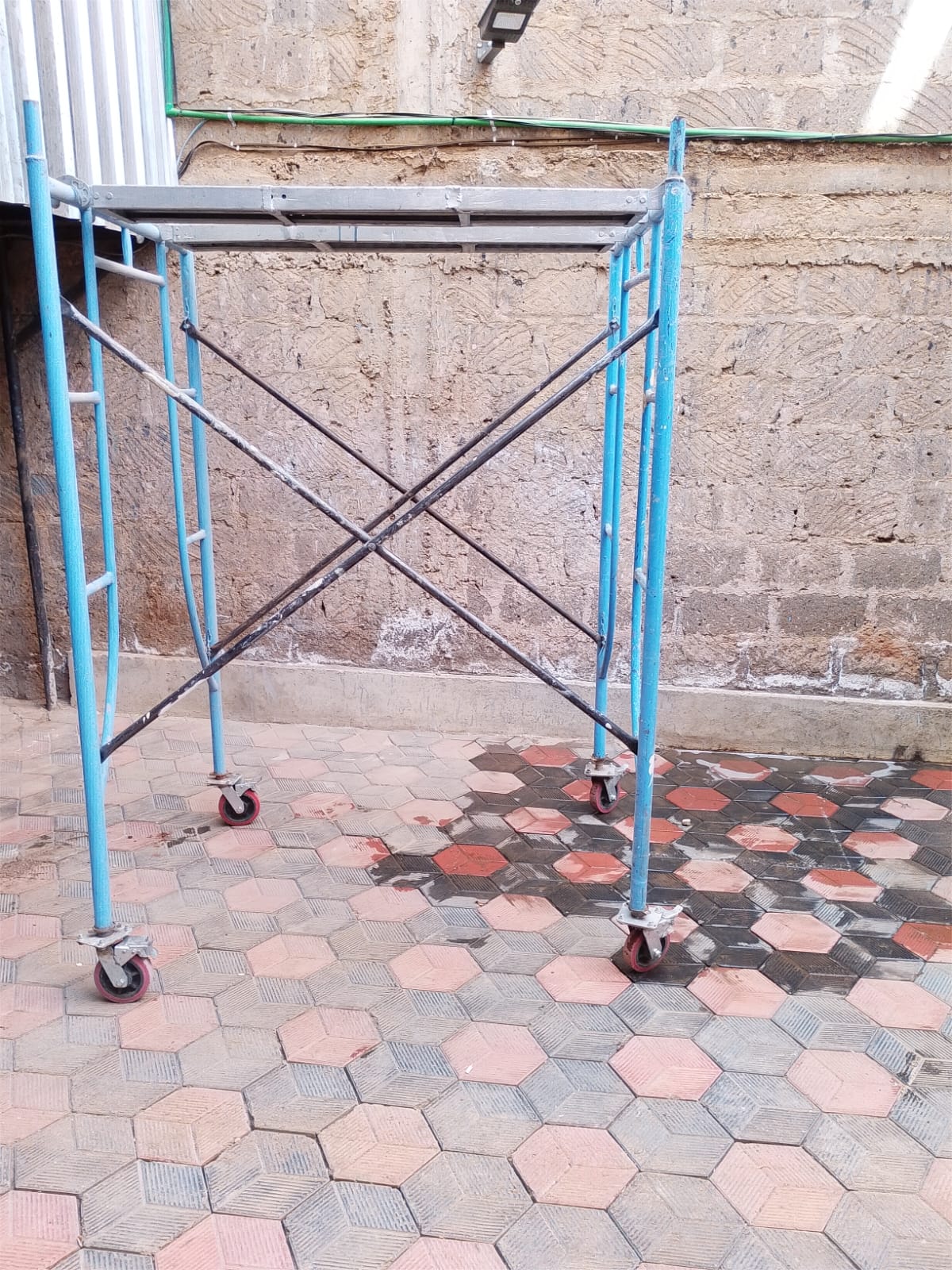 Mobile scaffold frame standing on castor wheels