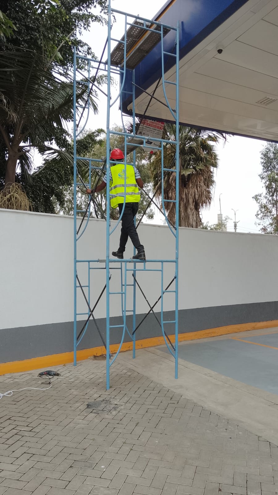 Technician working at height on a mobile scaffold tower